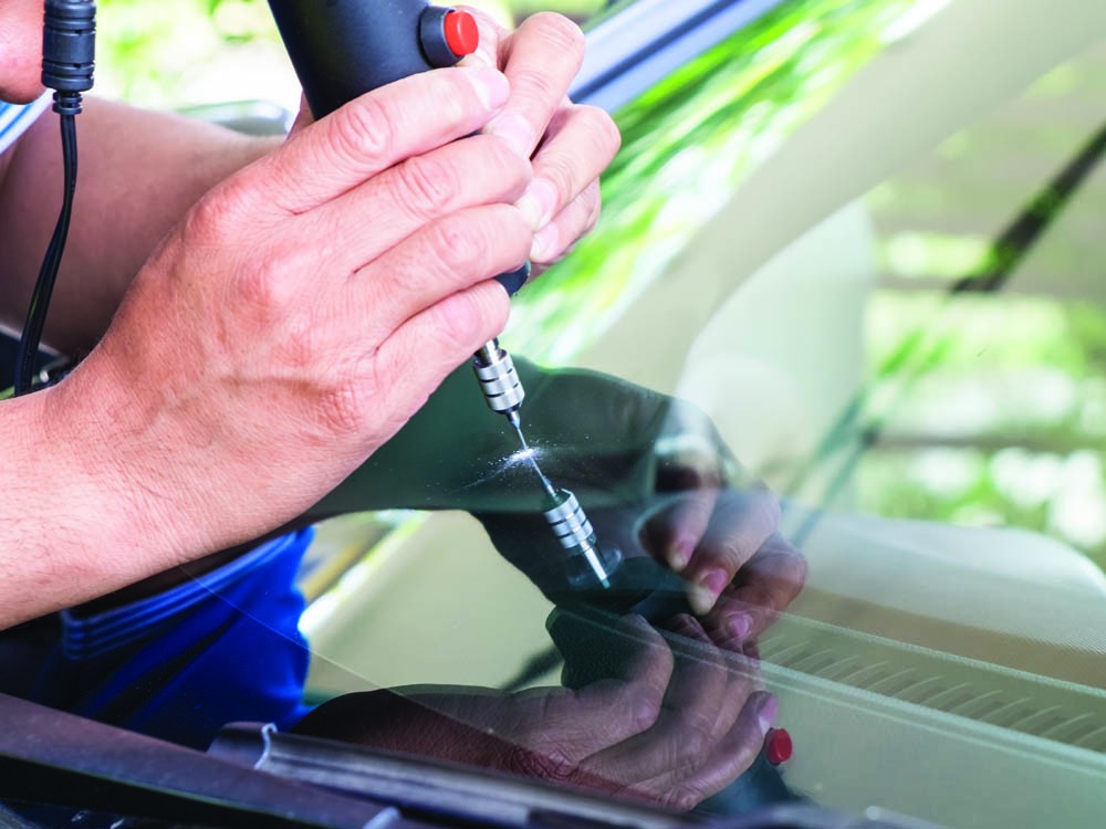 Windshield crack being fixed